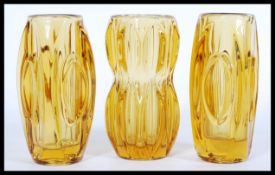 A group of three riihimaki type amber glass vases by Sklo with faceted lozenges, one being of