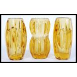 A group of three riihimaki type amber glass vases by Sklo with faceted lozenges, one being of