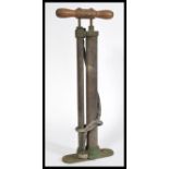 An early 20th century motoring related foot pump with wooden handle with its original rubber
