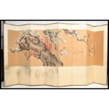 A vintage early 20th Century Japanese eight fold room divider, hand painted panel running throughout