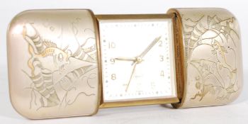 A vintage 20th century sliding pull out desk top alarm travelling clock by Europa in white metal