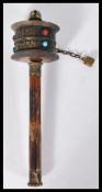 An antique 19th century Mongolian child's rattle spinner with calligraphy lettering and applied