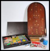 A vintage bagatelle board along with a vintage games compendium set and other various games.