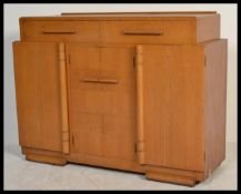 A 1930's Art Deco oak sideboard of shaped form having short drawers over 3 cupboards beneath