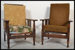 A pair of early 20th century Arts & Crafts revival stick back reclining armchairs having spindle