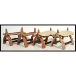 A collection of 5 vintage 20th century hardwood and brass adorned camel stools of varying shapes and