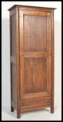A 20th Century oak hall cupboard / sentry box wardrobe. The paneled single door opening to reveal