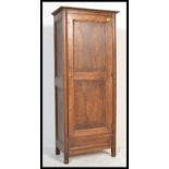 A 20th Century oak hall cupboard / sentry box wardrobe. The paneled single door opening to reveal