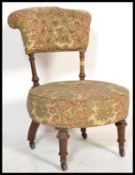 A 19th Century Victorian mahogany framed nursing chair, over stuffed circular seat pad with button