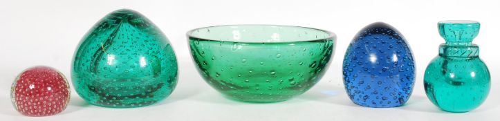 A group of coloured glass desk and table ornaments to include a large green Whitefriars glass