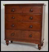 A Victorian mahogany 2 over 3 chest of drawers raised on bun feet having knob handles
