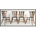 A set of four vintage 20th century Ercol Fleur De Lys dining chairs having a triple splat back fleur