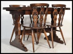 A vintage 20th century Ercol mahogany circular extending dining table along with a set of four Ercol