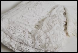 A vintage early 20th century square white linen table cloth with extensive crochet detailing with