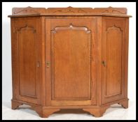 A vintage retro 20th century oak buffet drinks cabinet sideboard having a shaped gallery top. The