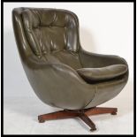 A 1970's retro swivel egg chair - armchair being raised on a teak 4 prong swivel base, the chair