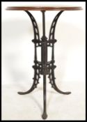 A 19th century Victorian cast iron occasional tavern / pub table raised on tripod scrolled and