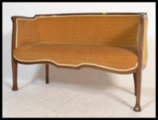 A good French early 20th century canape / conversation two seat sofa in mahogany having reeded,
