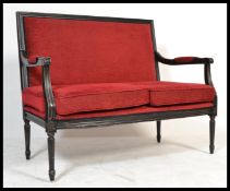 A vintage 20th Century French Louis style ebonised frame conversation Canape sofa settee being