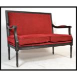 A vintage 20th Century French Louis style ebonised frame conversation Canape sofa settee being