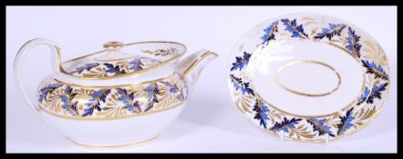 A early 19th century Derby teapot and stand circa 1820 having gilt work to the rim and cobalt