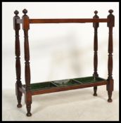 An early 20th century Edwardian mahogany walking stick stand with three compartments, having