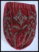 A late 17th century silk ladies drawstring coin purse with kid leather lining with metal beading