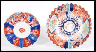 A pair of early 20th century Japanese Imari charger plates having hand painted details and