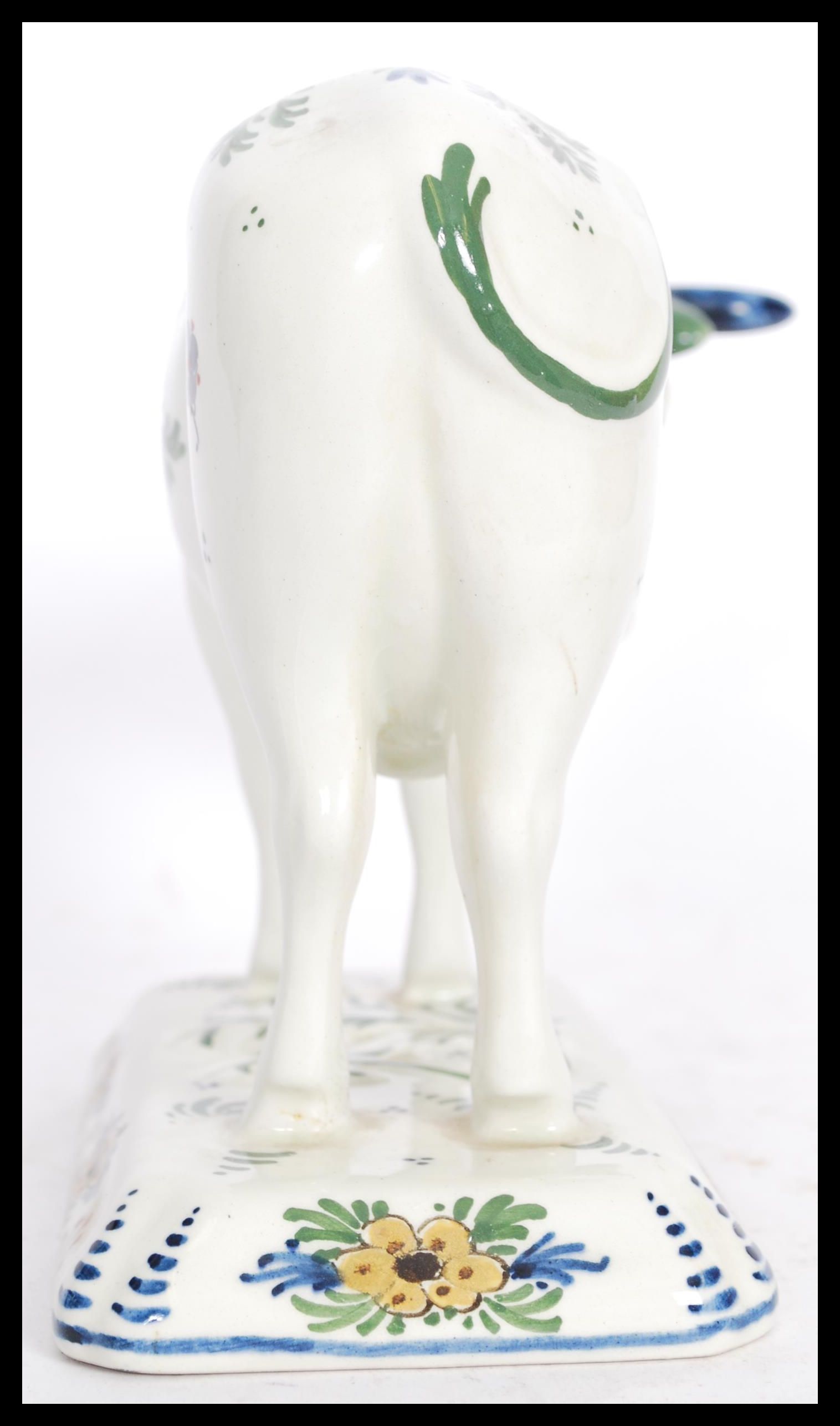 A 19th / 20th Century Delft ceramic figurine of a cow having hand painted floral sprays with painted - Image 4 of 8