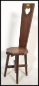 A carved oak Welsh spinning chair, early 20th Century Arts and Crafts. The carved high back with a