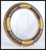 A 19th century Italian gilded and painted circular picture frame having cobalt and gilt deatiling