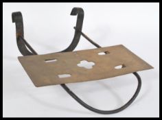 A 19th Century cast metal sliding fireplace trivet, hanging hooks to the back and slide to the