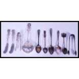 A group of sterling silver and other flatware to include tea spoons, armorial spoons, white metal