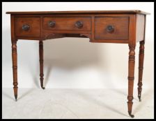 A Victorian mahogany writing table desk being raised on turned legs with arched kneehole recess