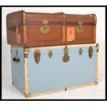 A pair of non matching steamer trunks to include a canvas and cane bound trunk from the early 20th