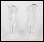 A pair of 19th century ceramic table taper candles