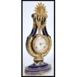 A 20th century ceramic mantle piece clock by Franklin Mint coloured cobalt with gilt garland