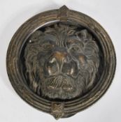 A 19th century bronze large door knocker in the form of a lions head with ring surround. Measures: