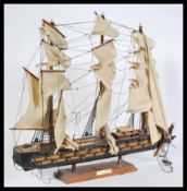 A vintage 20th century  scratch built model of a three masted galleon with sails and rigging. Raised