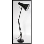 A mid 20th century retro industrial Herbert Terry Anglepoise desk lamp raised on a circular base