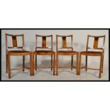 A set of four 20th Century Art Deco dining chairs, drop in seats, slat back raised on turned legs