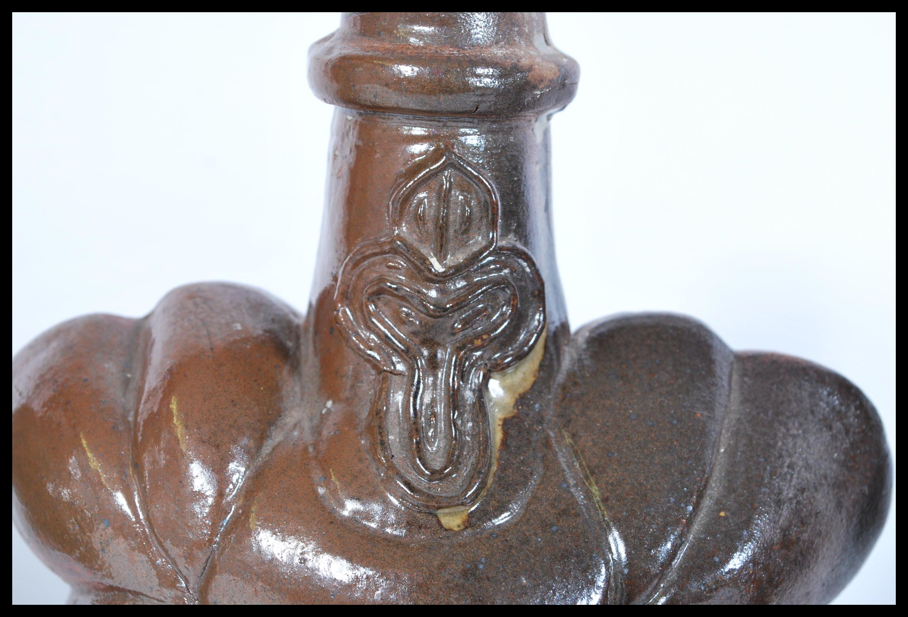 Three 17th century salt glazed stoneware jars based on bellarmine of unusual form having bulbous - Image 2 of 5