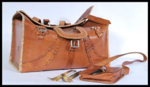 A pair of leather African carry bag by Chui with a fabric lining and leather stitching detail and