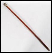 A 20th Century cane walking stick, surmounted with a resin top modeled as an owl, raised on tapering