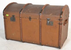 A vintage early 20th Century dome top canvas and cane bound steamer trunk, brass locks fitted to the