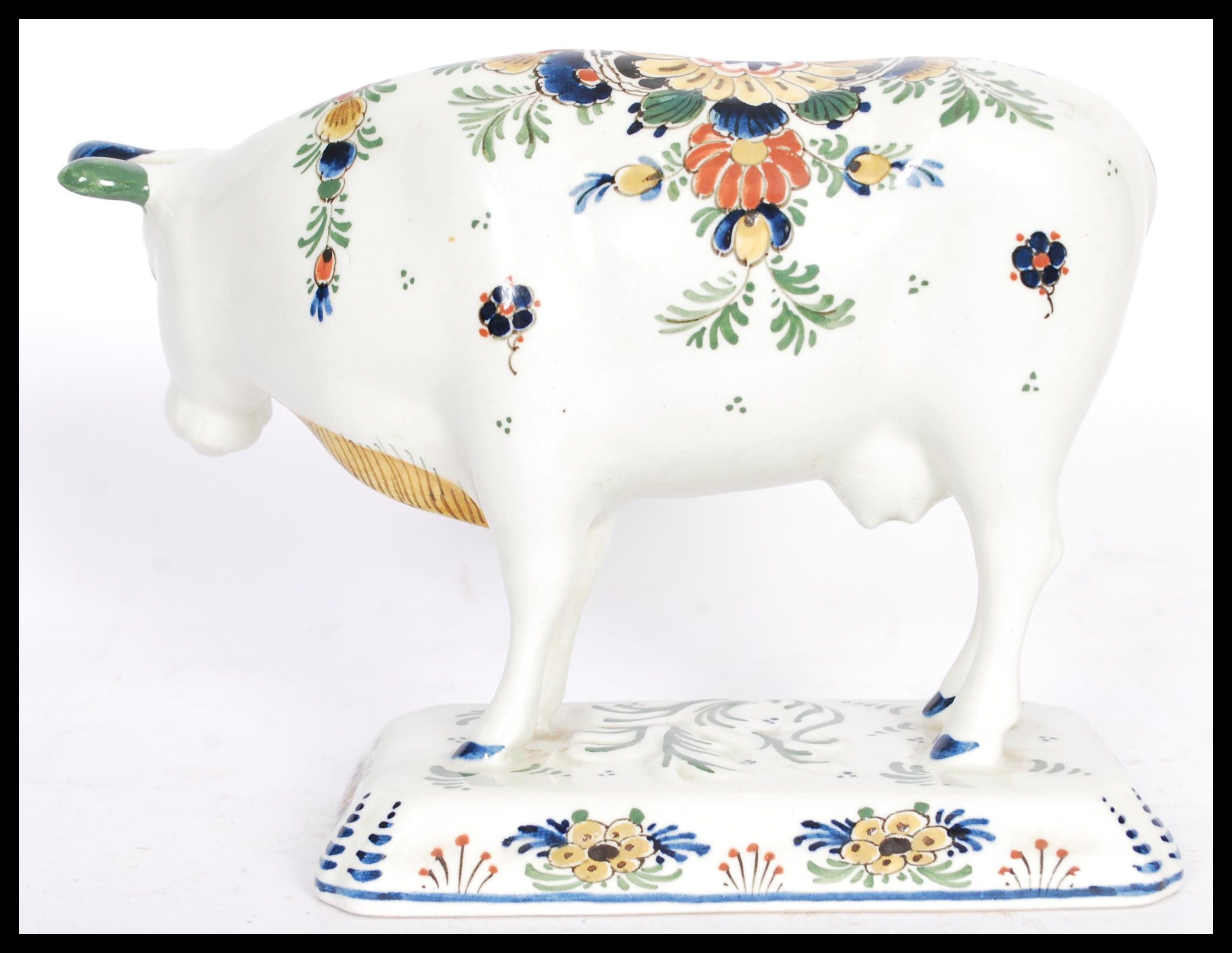 A 19th / 20th Century Delft ceramic figurine of a cow having hand painted floral sprays with painted - Image 3 of 8