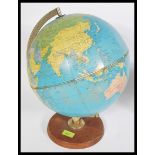 A vintage retro 20th century Philips 12" Political Challenge desk top globe being raised on circular