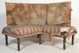A 19th century Georgian corner sofa  - conversation settee settle being raised on mahogany turned