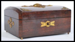 A 19th century French Palaise Royale rosewood jewellry box with brass mounts having a domed top with