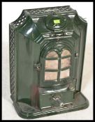 A French early 20th century green enamel stove in the manner of Godin having shaped facia and